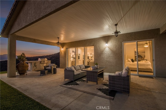 patio terrace at dusk featuring french doors and an outdoor living space