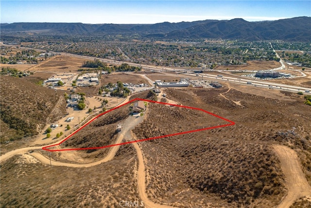 birds eye view of property featuring a mountain view