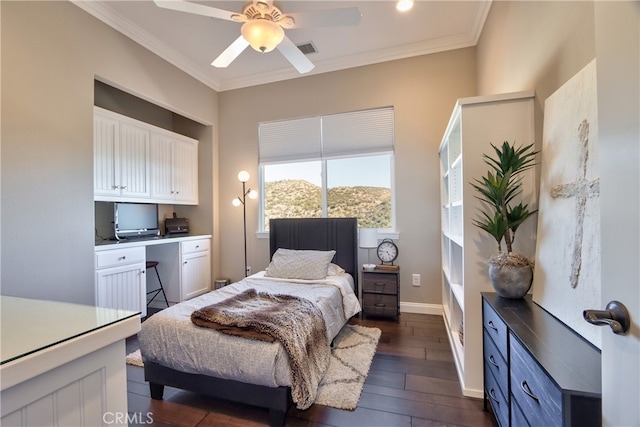 bedroom featuring dark wood-type flooring, ceiling fan, crown molding, and built in desk