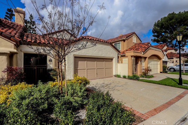 mediterranean / spanish-style house with a garage