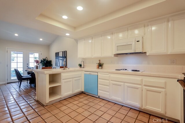 kitchen featuring kitchen peninsula, white cabinets, light tile patterned floors, french doors, and white appliances