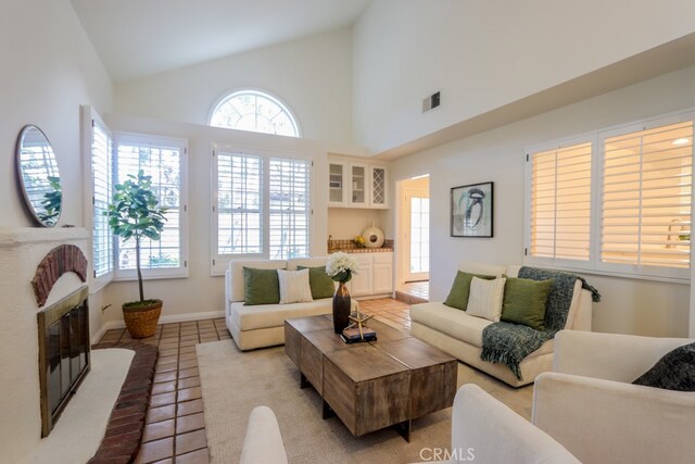 tiled living room with high vaulted ceiling