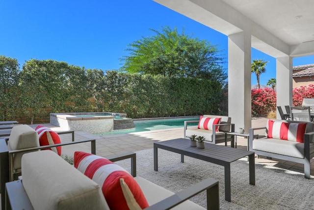 view of patio featuring an outdoor living space and a pool with hot tub