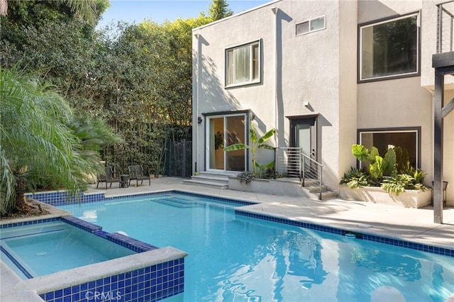 view of swimming pool with an in ground hot tub