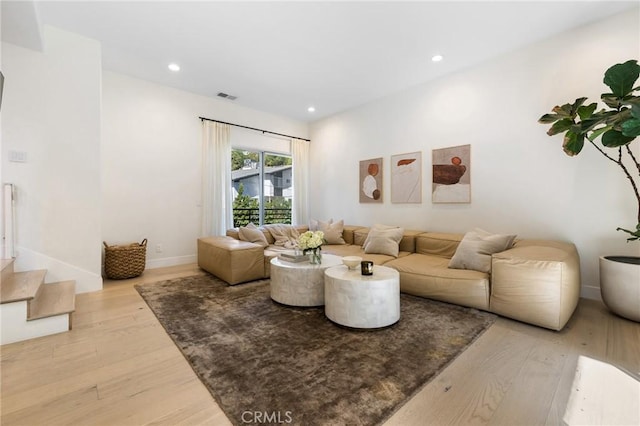 living room with light hardwood / wood-style flooring