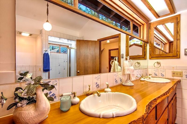 bathroom with vanity and tasteful backsplash