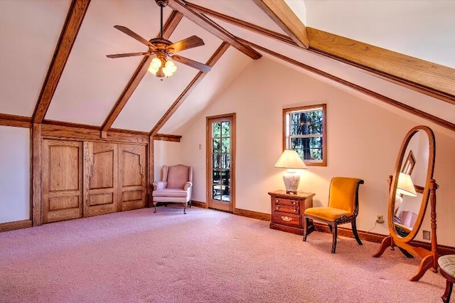 living area featuring light carpet, vaulted ceiling with beams, and ceiling fan