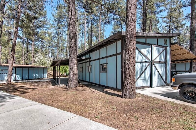 view of home's exterior with an outbuilding and a carport