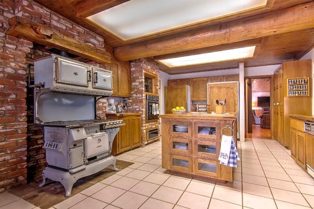 kitchen featuring oven, brick wall, and light tile patterned floors