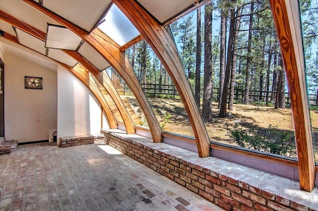 unfurnished sunroom with vaulted ceiling and a wealth of natural light