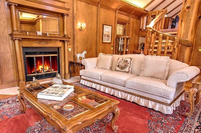 living room featuring vaulted ceiling and wood walls