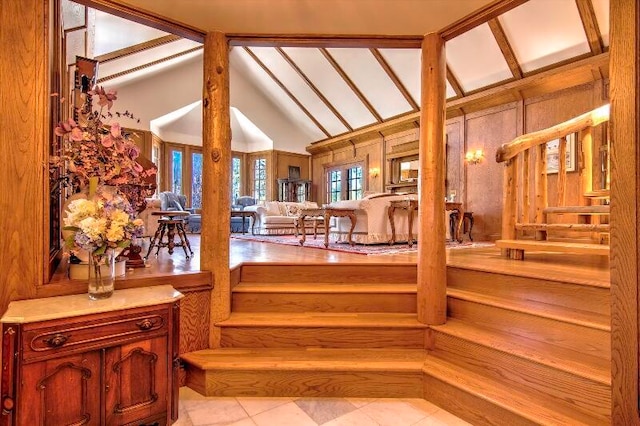 stairs with french doors and vaulted ceiling with beams