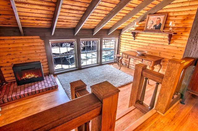 living room featuring wood-type flooring, beamed ceiling, wooden ceiling, and rustic walls