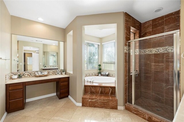 bathroom with plus walk in shower, vanity, and tile patterned flooring