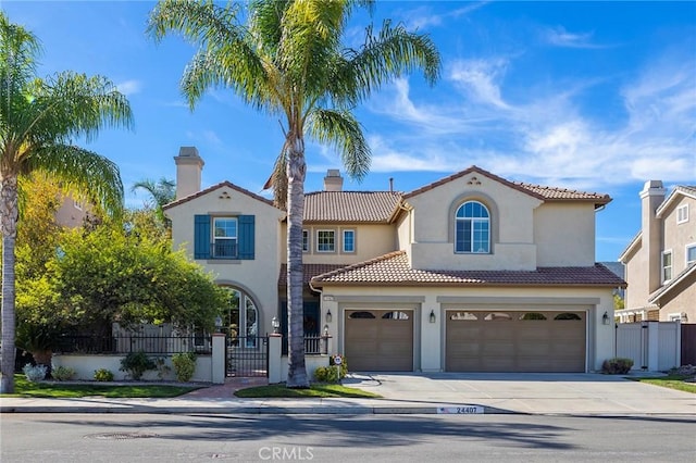 mediterranean / spanish-style home with a garage