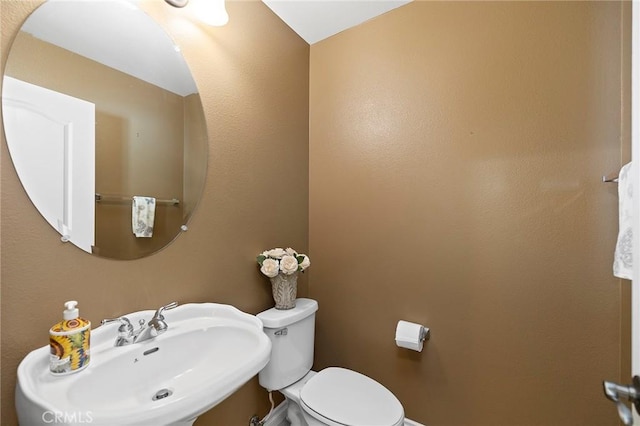 bathroom featuring sink and toilet