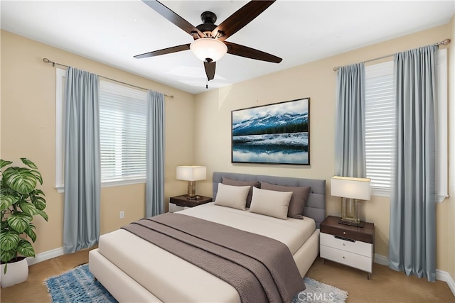 bedroom with ceiling fan and light carpet