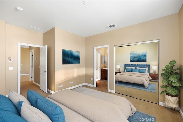 bedroom featuring carpet flooring and ensuite bath