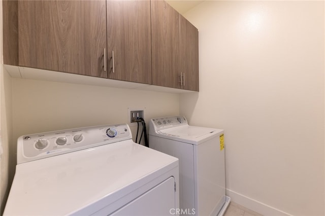 laundry area with cabinets and washing machine and dryer