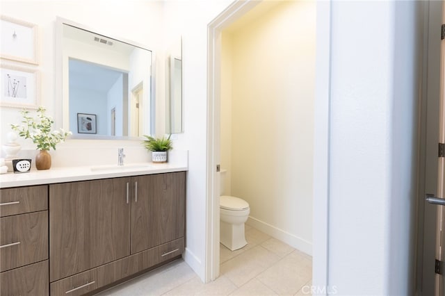 bathroom featuring tile patterned floors, vanity, and toilet