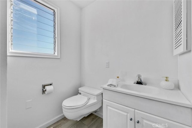 bathroom with wood-type flooring, toilet, and vanity