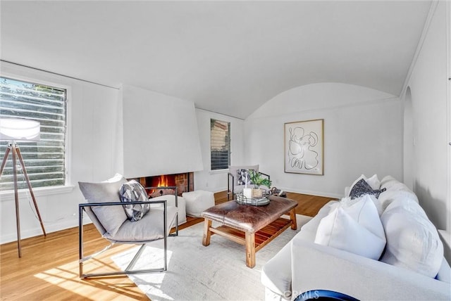 living room with brick ceiling, a healthy amount of sunlight, hardwood / wood-style floors, and vaulted ceiling