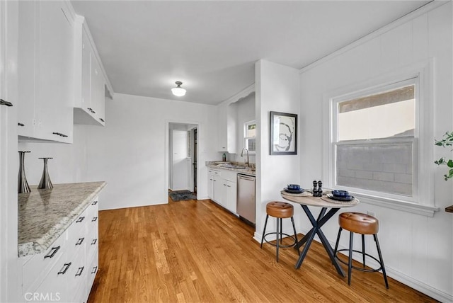 kitchen with white cabinetry, light wood-type flooring, dishwasher, light stone countertops, and sink