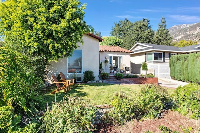 rear view of property featuring a lawn