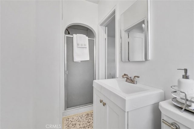 bathroom with walk in shower and vanity