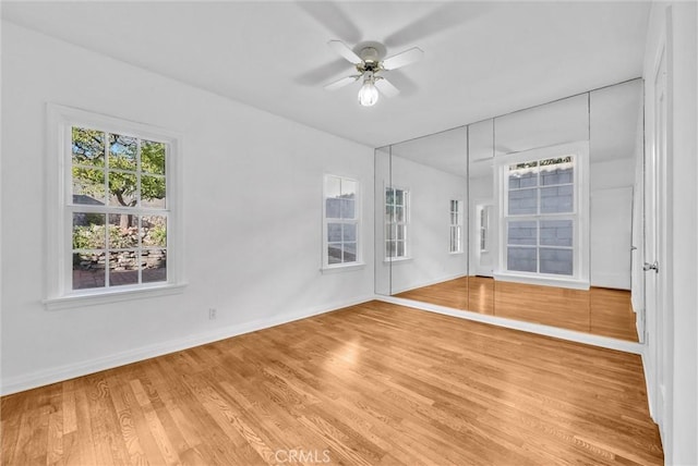 spare room with ceiling fan and hardwood / wood-style flooring