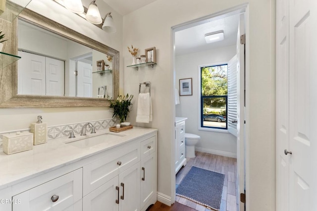 bathroom featuring hardwood / wood-style floors, vanity, and toilet