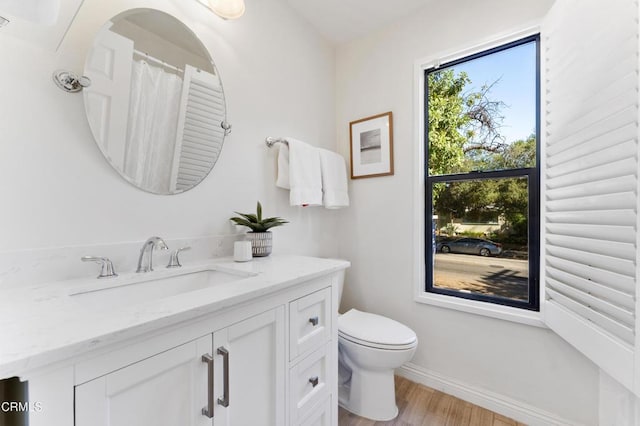 bathroom featuring hardwood / wood-style floors, vanity, and toilet