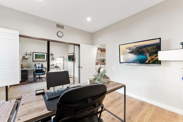 office area featuring washer / dryer and light hardwood / wood-style flooring