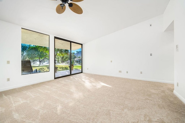 carpeted empty room with vaulted ceiling and ceiling fan