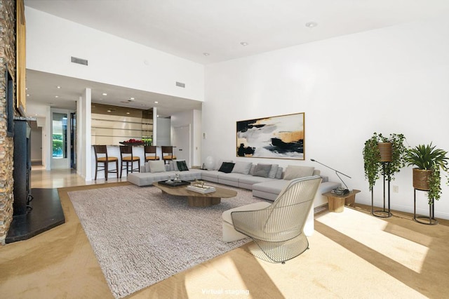 living room with a towering ceiling