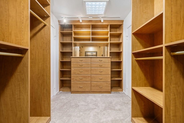 walk in closet featuring light carpet