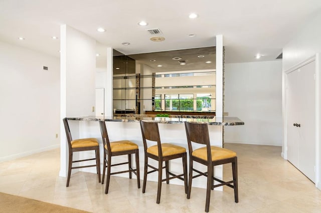 bar featuring dark stone countertops