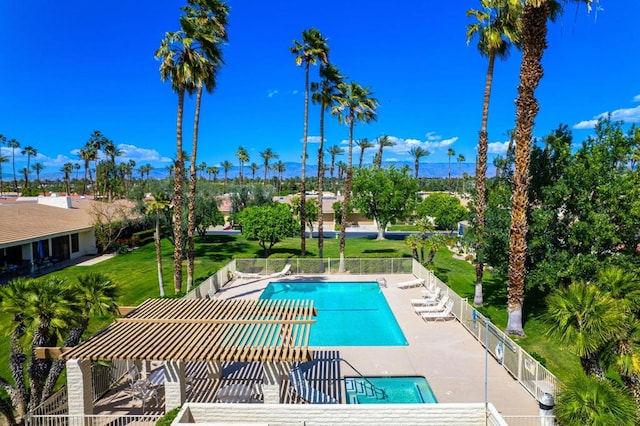 view of pool featuring a patio area and a yard