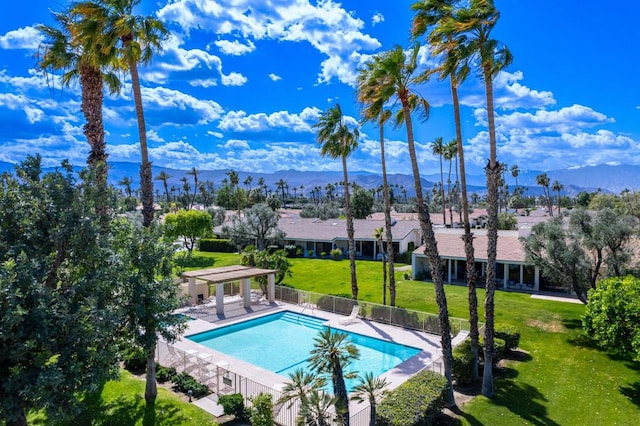 view of swimming pool with a mountain view, a yard, and a patio