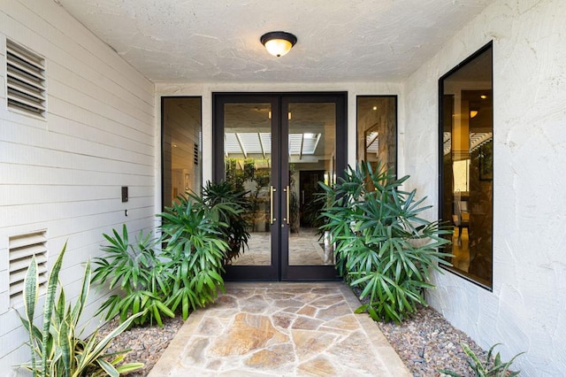 view of exterior entry featuring french doors