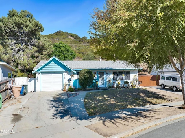 ranch-style house with a mountain view and a garage