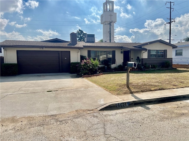 single story home featuring a front yard and a garage