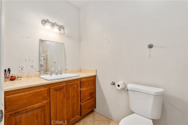 bathroom with vanity, toilet, and tile patterned flooring