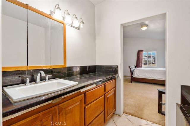 bathroom featuring vanity, lofted ceiling, and tile patterned flooring