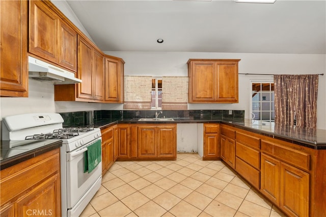 kitchen featuring sink, white gas range oven, and light tile patterned floors