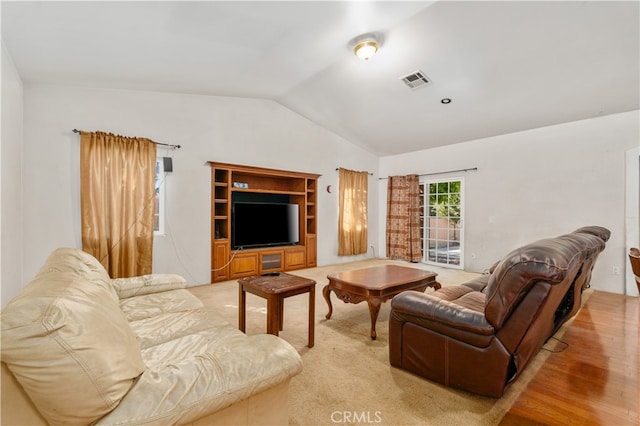 living room with lofted ceiling and light wood-type flooring