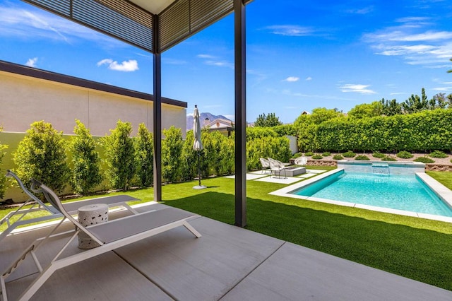 view of swimming pool with a patio and a yard