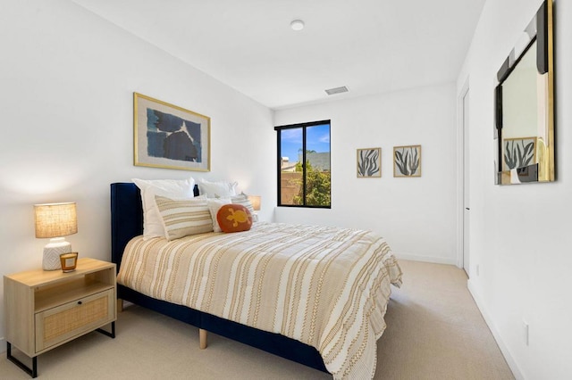 bedroom with light colored carpet