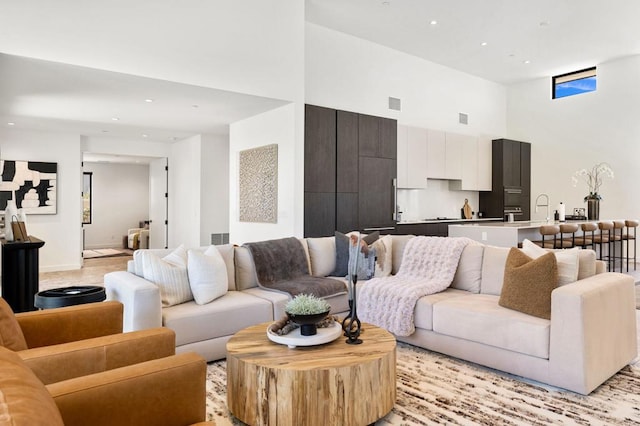 living room featuring a towering ceiling