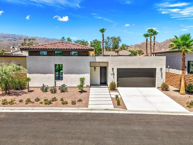 view of front of home with a mountain view and a garage